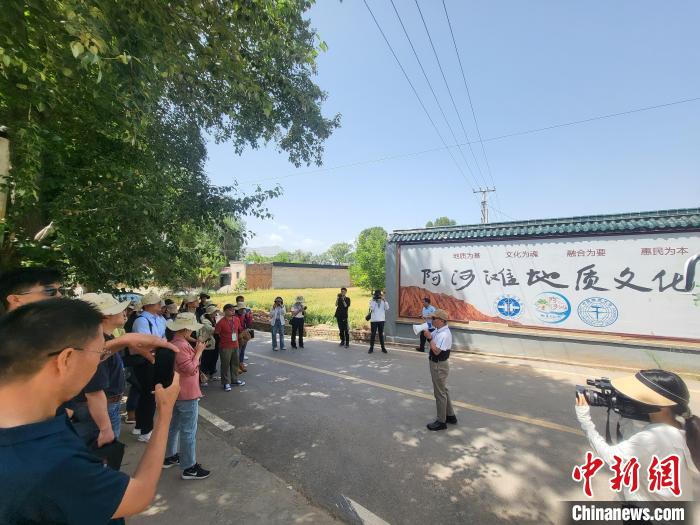 圖為中國地質(zhì)大學(xué)(北京)教授張緒教介紹村落情況?！『衍?攝