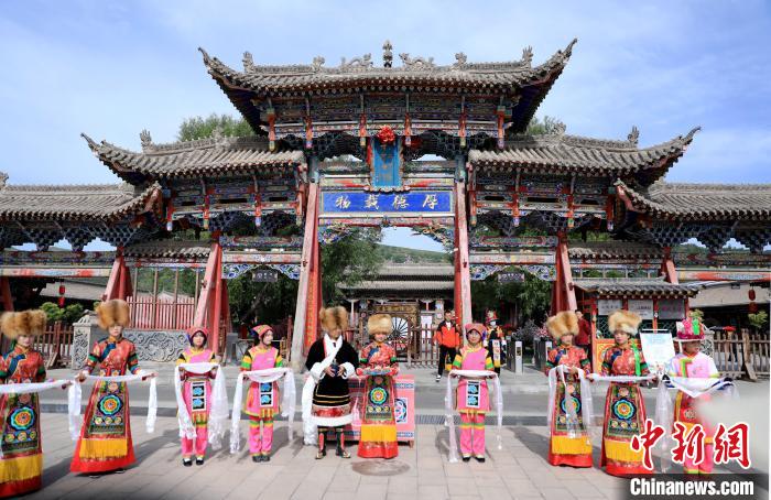 圖為身穿土族服飾的工作人員迎接訪客?！⊙Φ?攝